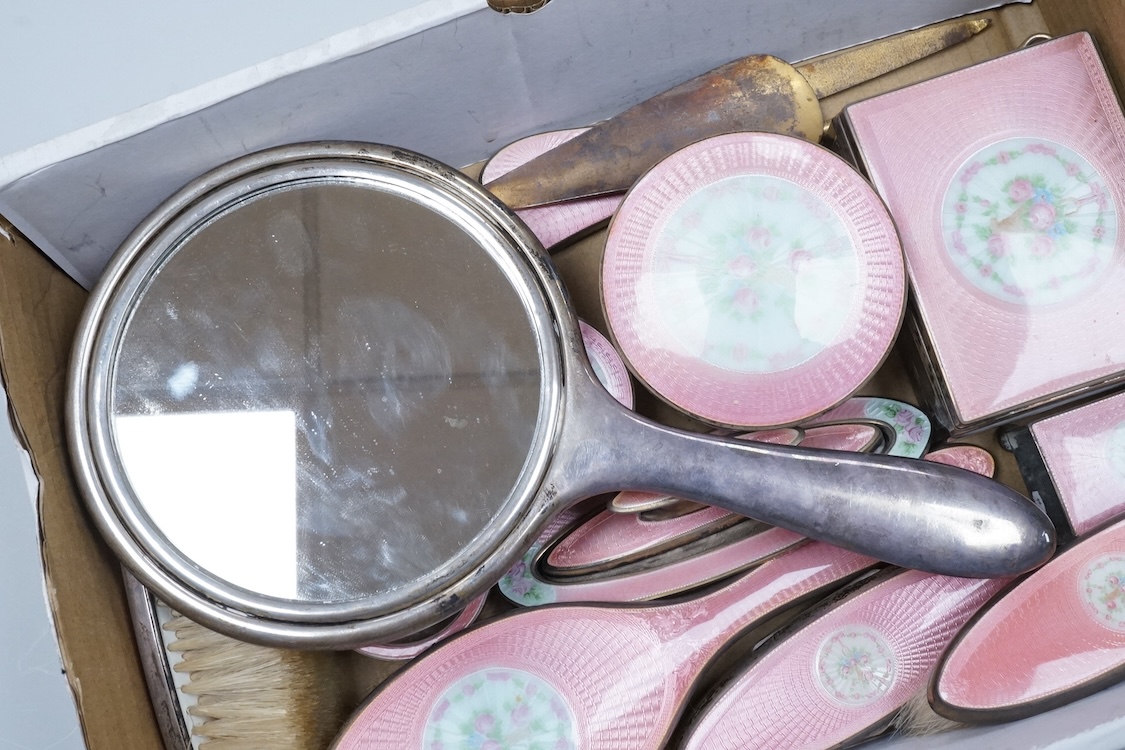 An early century North American sterling and enamel dressing table set by Theodore W. Foster & Bro, comprising fourteen items including hand mirror, 29.1cm, brushes, trinket box, nail buffer on stand, toilet jars, powder